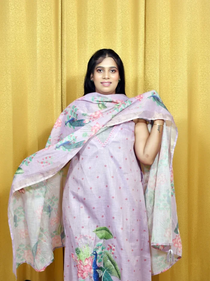 Woman in Graceful Lavender Salwar Suit with Peacock Motif and Floral Dupatta