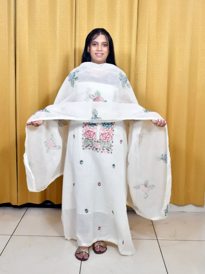 Woman in Elegant White Embroidered Salwar Suit with Floral Dupatta